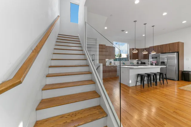 a bathroom with a granite countertop toilet a sink and a mirror