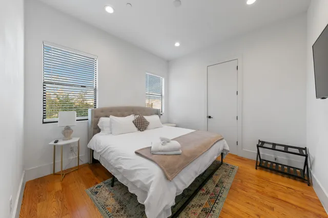 a bedroom with a bed and a window