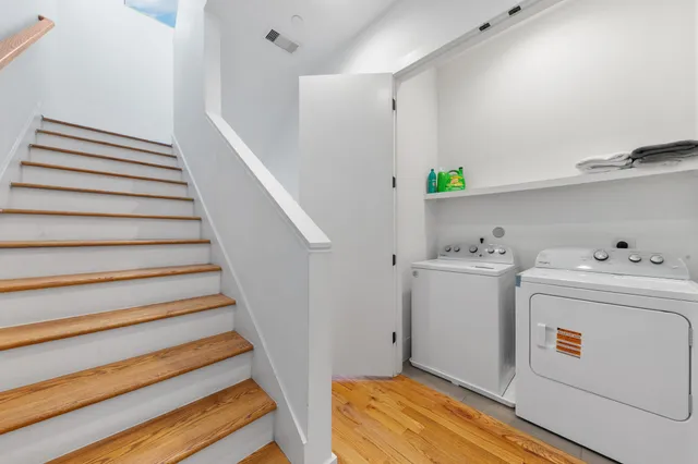 a bathroom with a sink a toilet a large mirror and shower