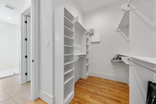 a bathroom with double sink and a shower
