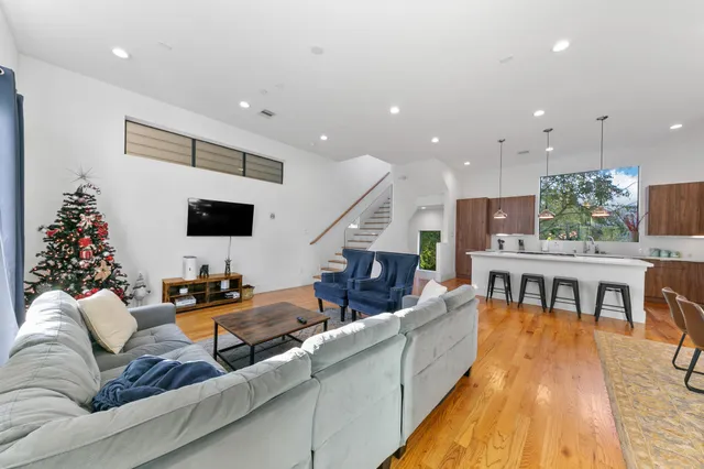 a living room with furniture and wooden floor
