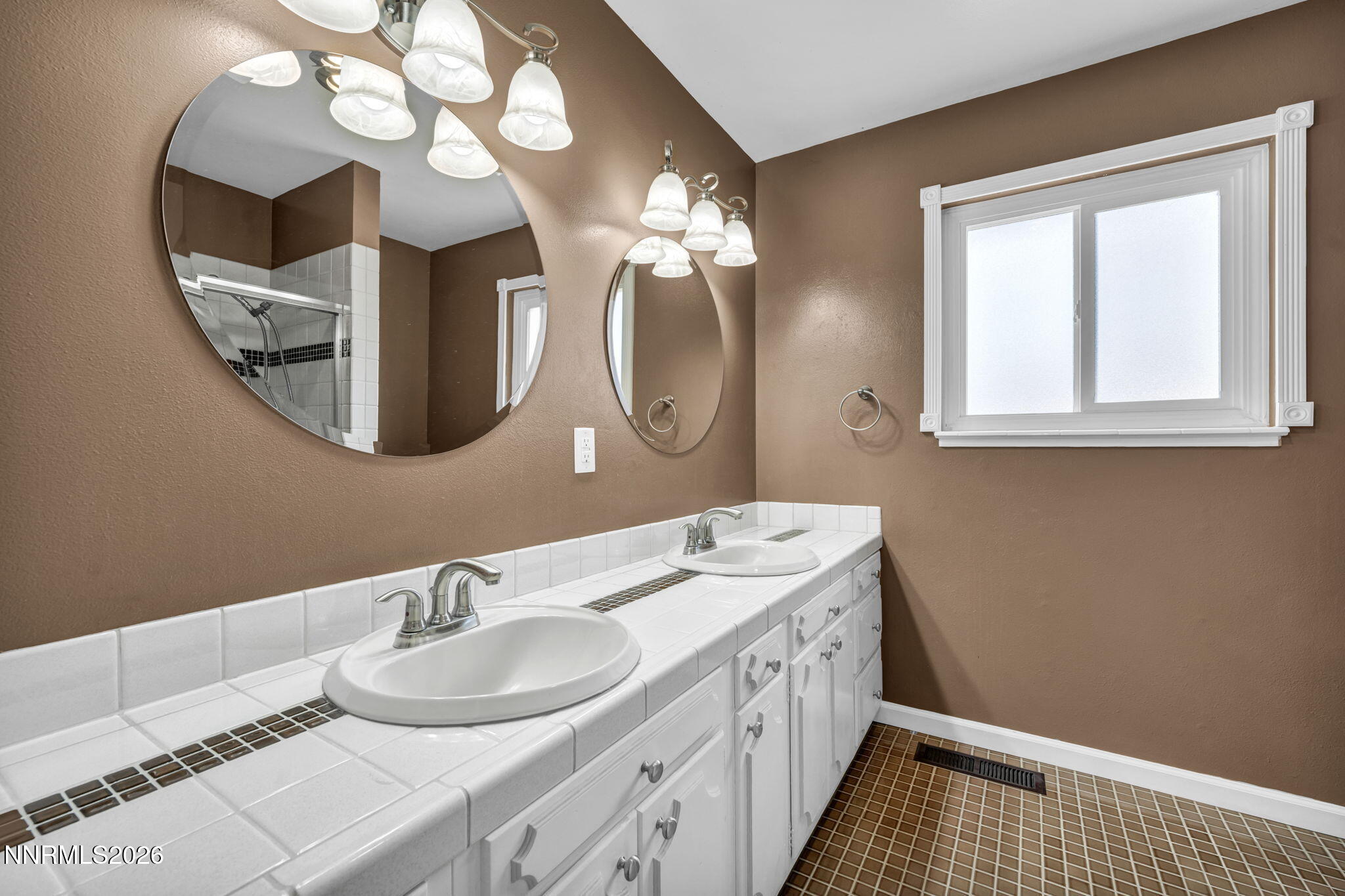 14190 Rim Rock Drive Reno, NV 89521 - Photo 42 of 68 a bathroom with a double vanity sink and a mirror