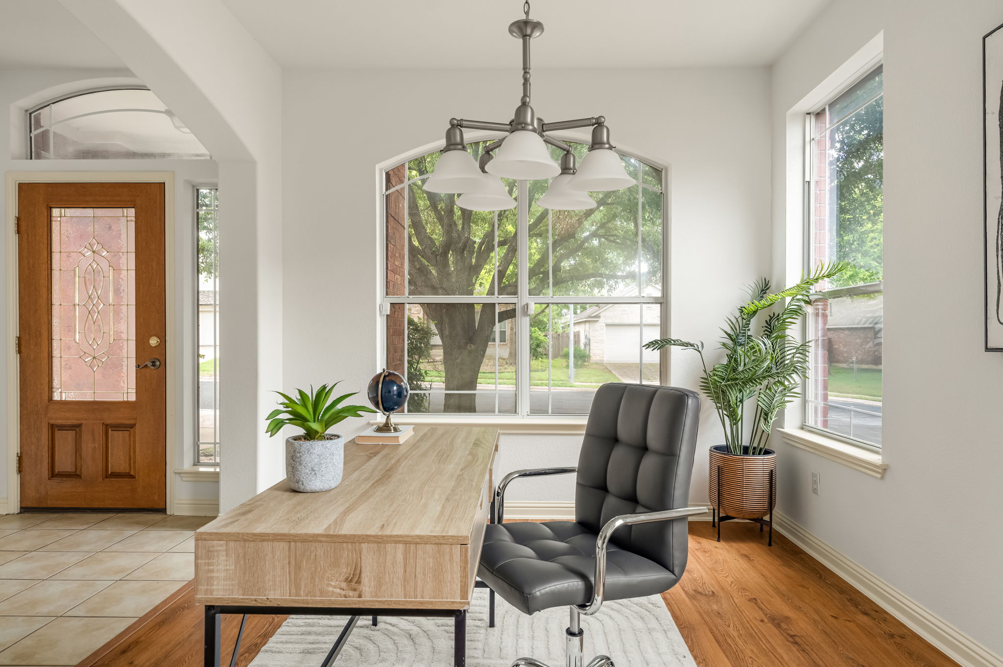10004 Isle Royale Way Austin, TX 78747 - Photo 4 of 31 An inviting entry opens into a bright, versatile office space with warm wood flooring.