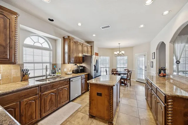 a large kitchen with lots of counter space and sink