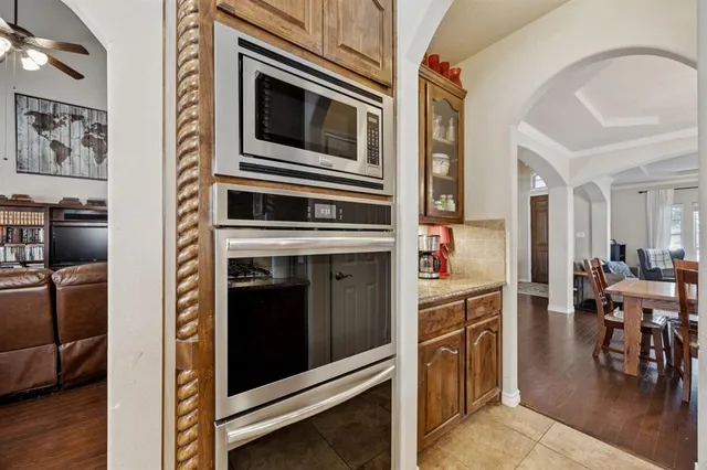 a kitchen with stainless steel appliances granite countertop a refrigerator and a stove top oven