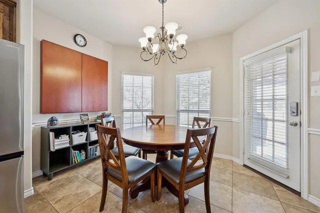 a dining room with furniture a chandelier and window