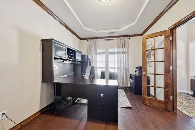 a hallway with a large window and wooden floor