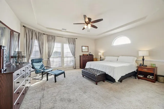 a spacious bedroom with a bed and a large window