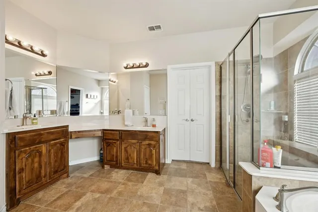 a large bathroom with a double vanity sink and a mirror