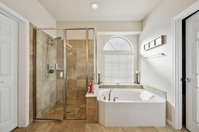 a bathroom with a bathtub and a shower