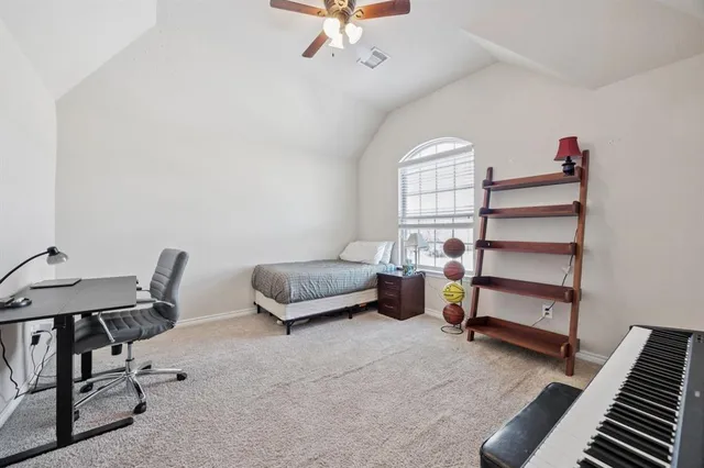 a bedroom with furniture and a window