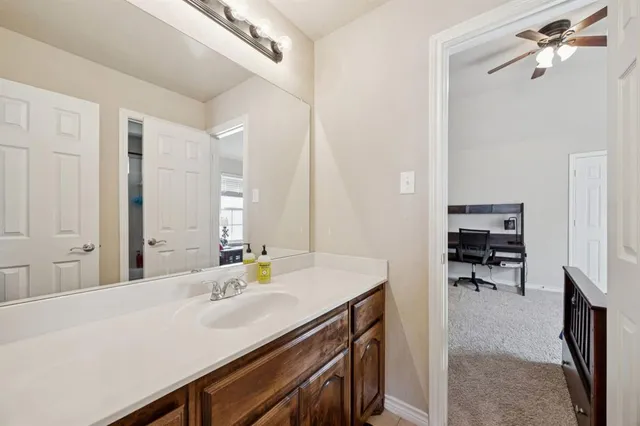 a en suite bathroom with a sink double vanity and a mirror