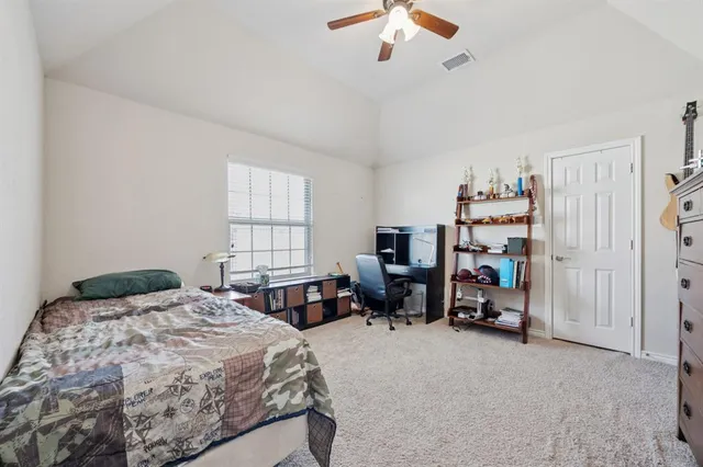 a bedroom with a bed couch and a window