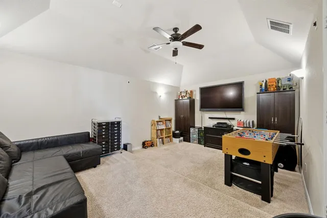 a bedroom with furniture and a flat screen tv