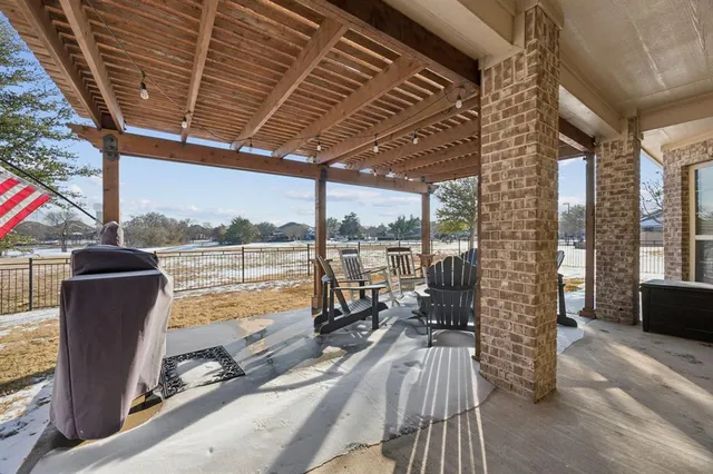 a view of a balcony with chairs and wooden floor