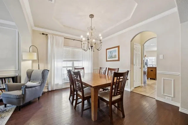 a view of a dining room with furniture wooden floor and chandelier