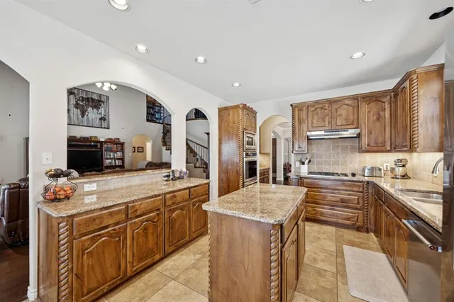 a kitchen with a stove top oven sink and cabinets
