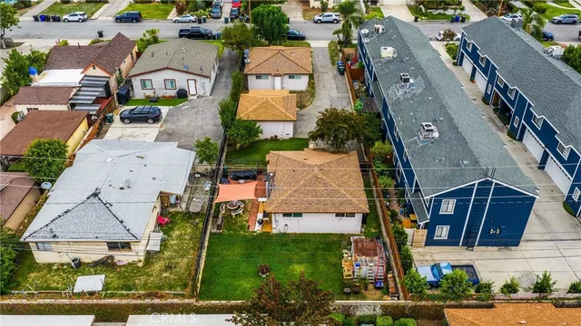 an aerial view of multiple houses with yard