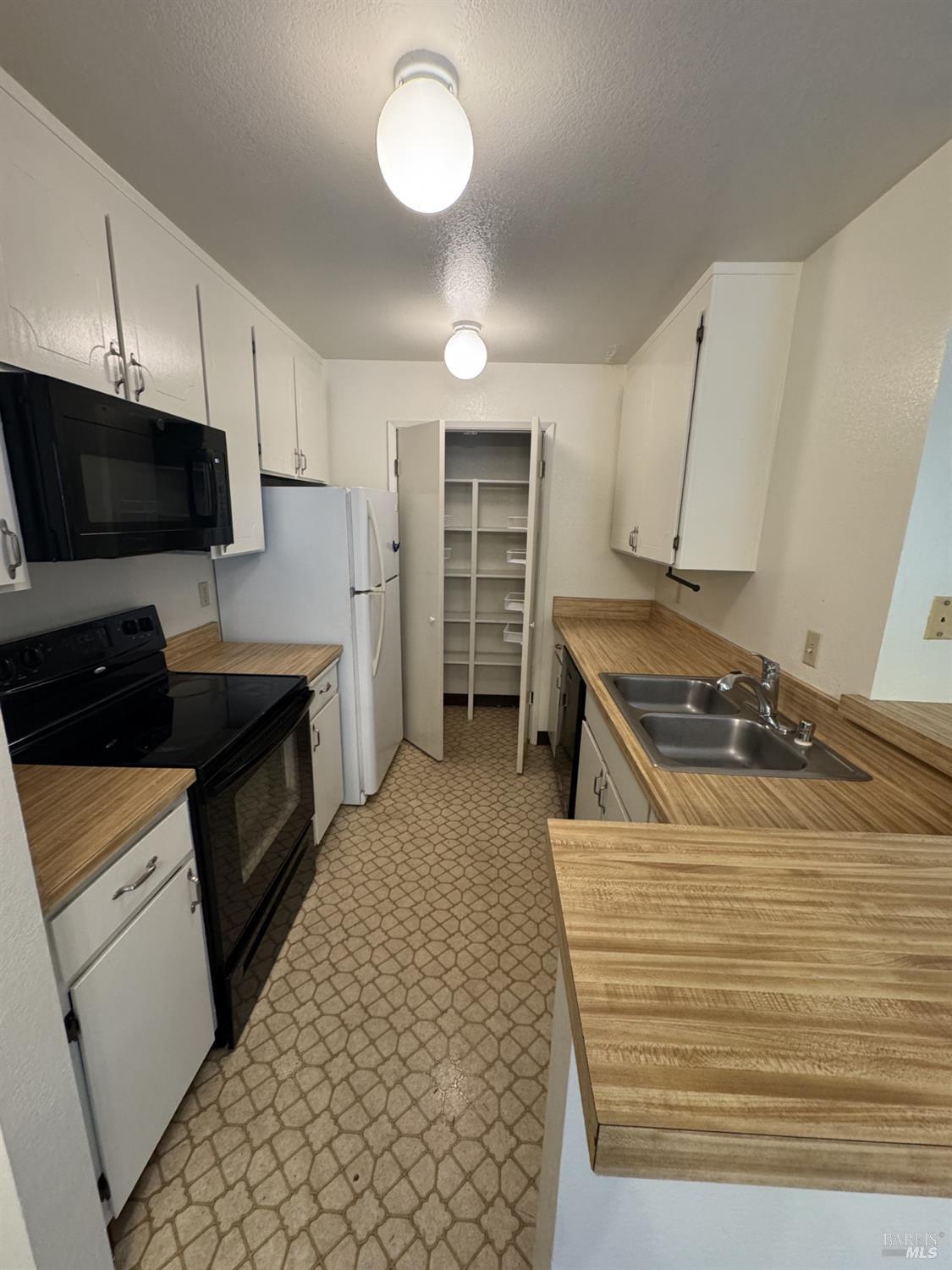 33 Lakeview Court Novato, CA 94947 - Photo 3 of 18 a kitchen with stainless steel appliances a stove a sink and a microwave