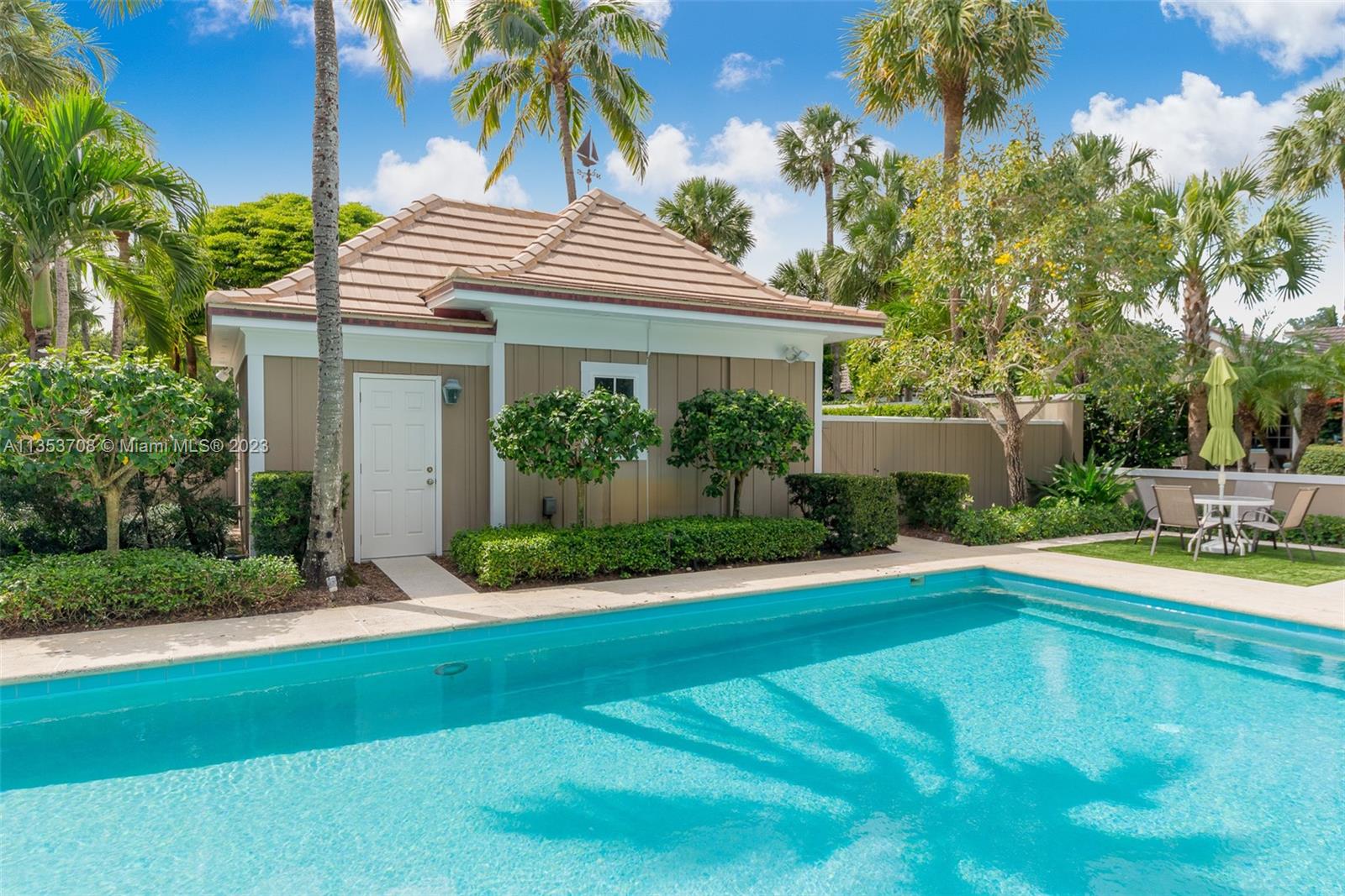 115 Gomez Road Jupiter Island, FL 33455 - Photo 13 of 20 a view of a house with a yard and palm trees