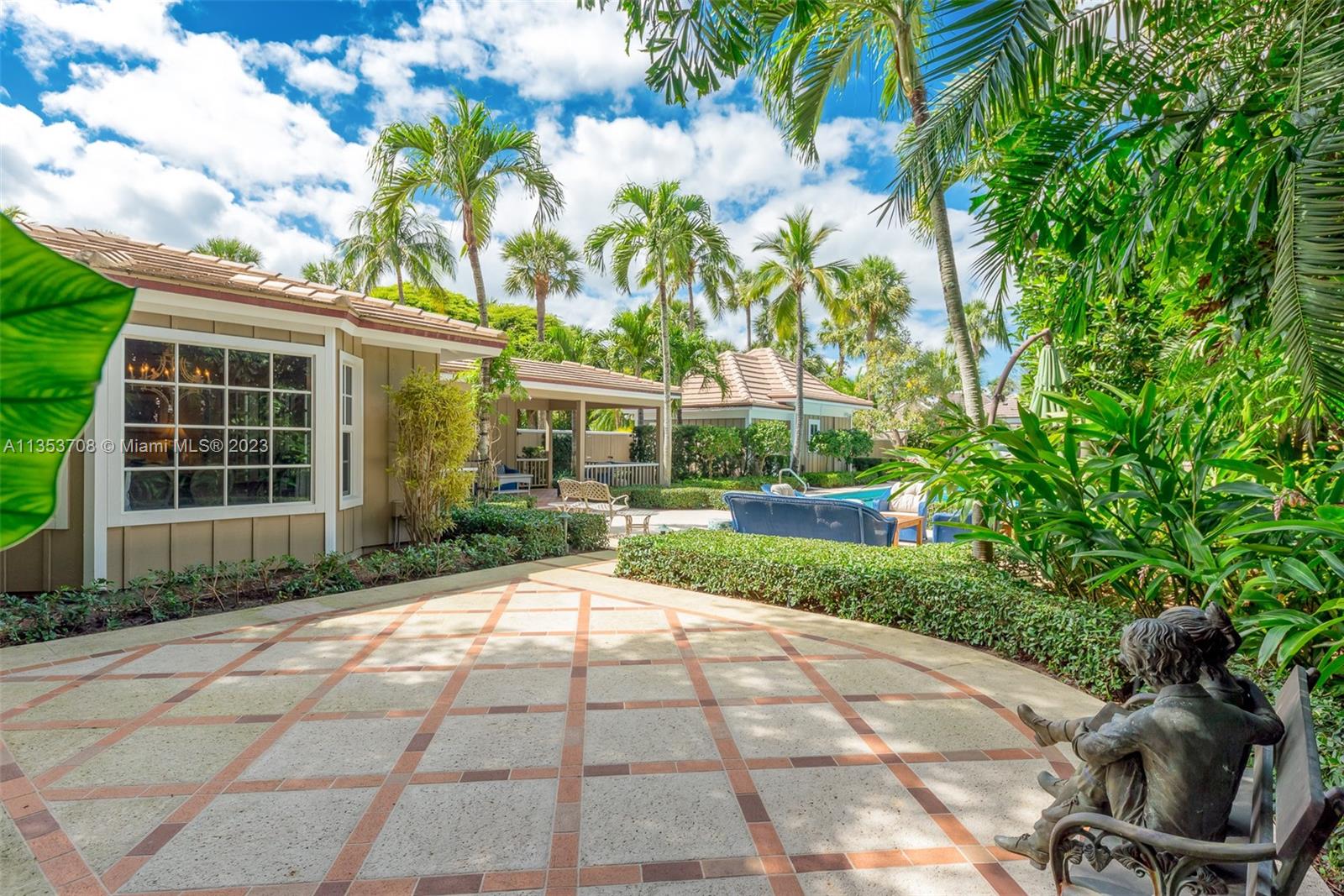115 Gomez Road Jupiter Island, FL 33455 - Photo 18 of 20 a view of a backyard with table and chairs and potted plants