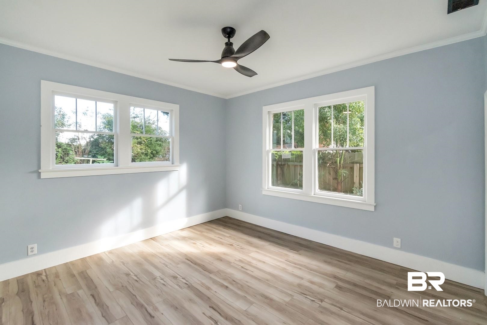 555 Michigan Avenue Mobile, AL 36604 - Photo 17 of 28 Spare room with a healthy amount of sunlight, light hardwood / wood-style floors, and crown molding