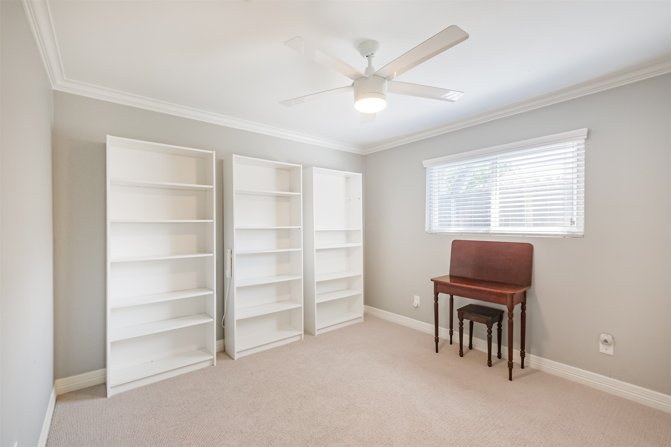 1007 Arrow Hill Road Houston, TX 77077 - Photo 30 of 48 The second bedroom has carpet floors, crown molding, a walk-in closet and updated ceiling fan.