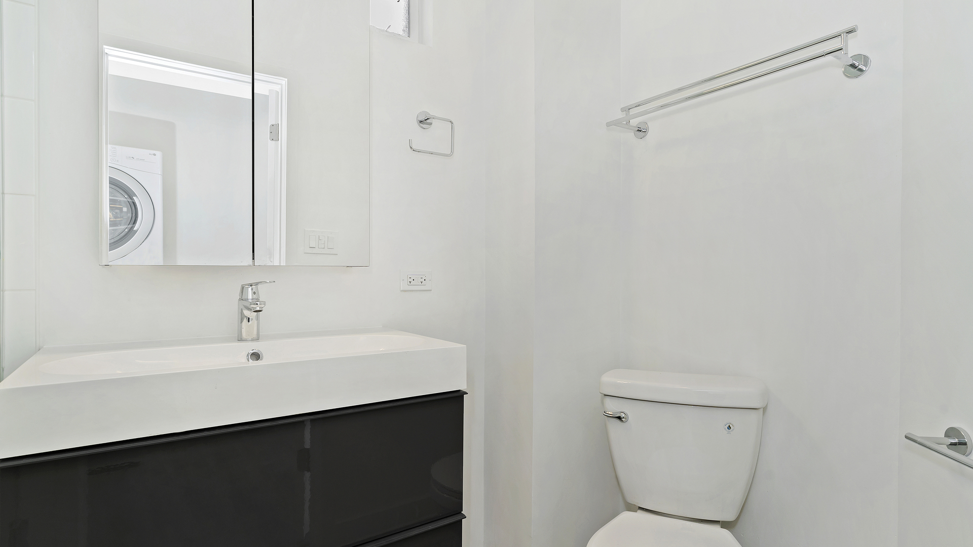 Undisclosed Address Chicago, IL 60622 - Photo 3 of 14 a bathroom with a sink a toilet and a mirror