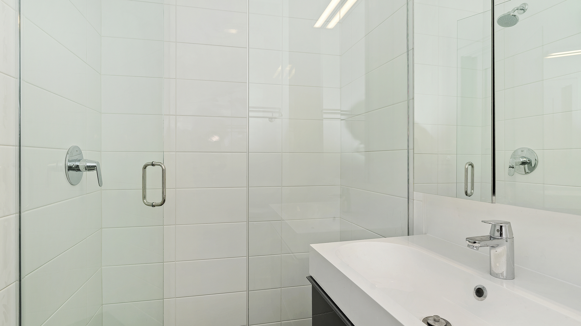 Undisclosed Address Chicago, IL 60622 - Photo 8 of 14 a bathroom with a sink a shower and a mirror