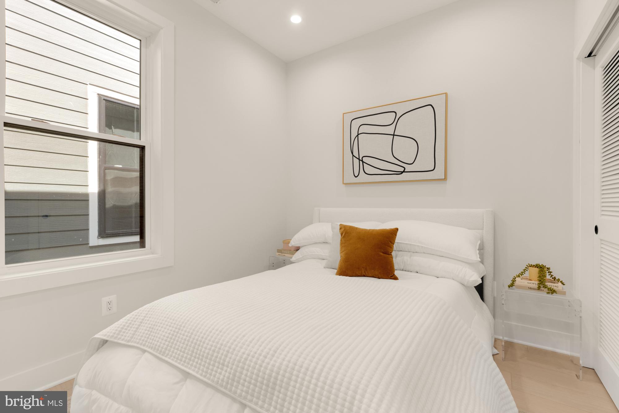 5505 7th Street Northwest, Unit 5 Washington, DC 20011 - Photo 12 of 27 a bedroom with a bed and painting on the wall