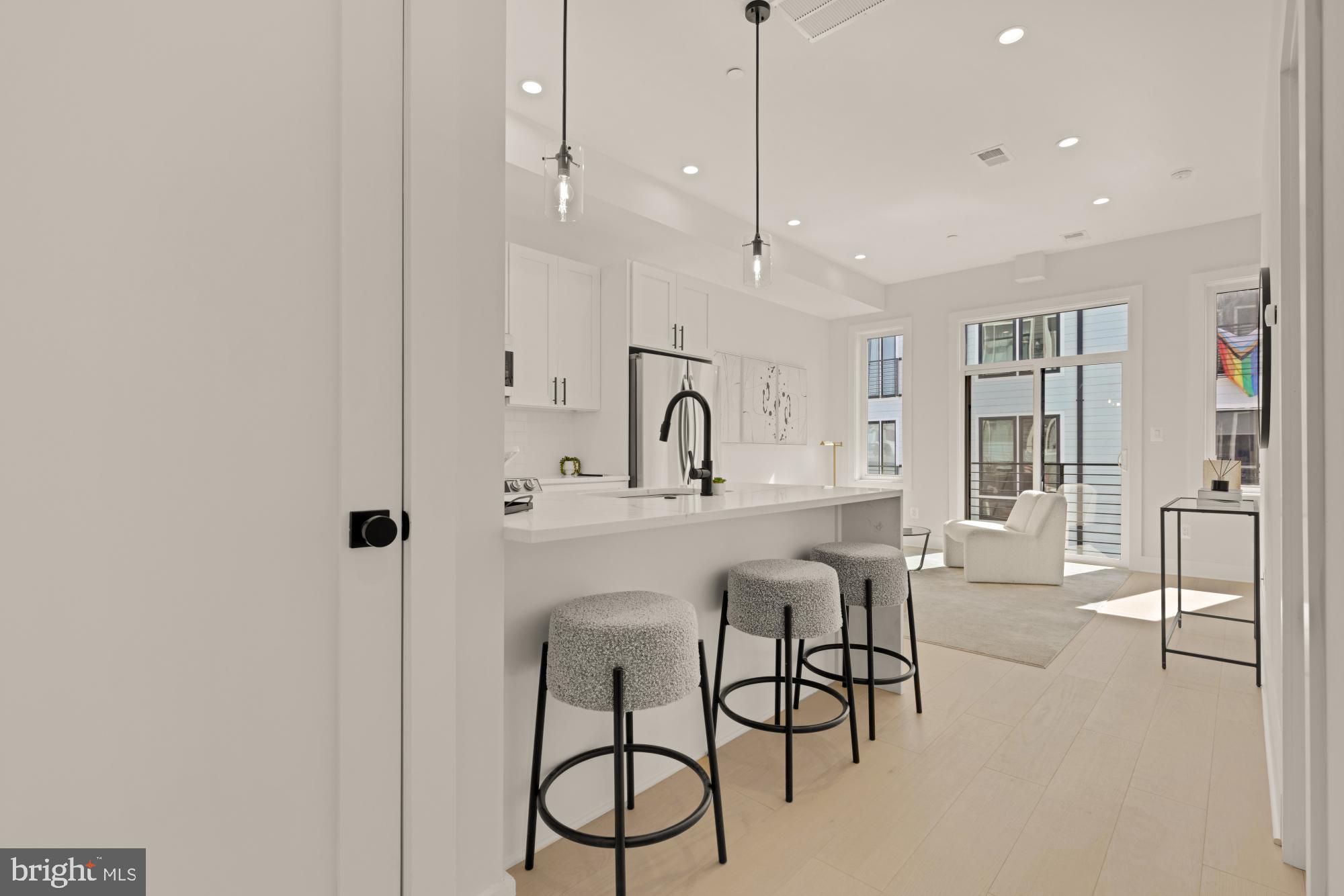 5505 7th Street Northwest, Unit 5 Washington, DC 20011 - Photo 5 of 27 a kitchen with stainless steel appliances a table and chairs in it