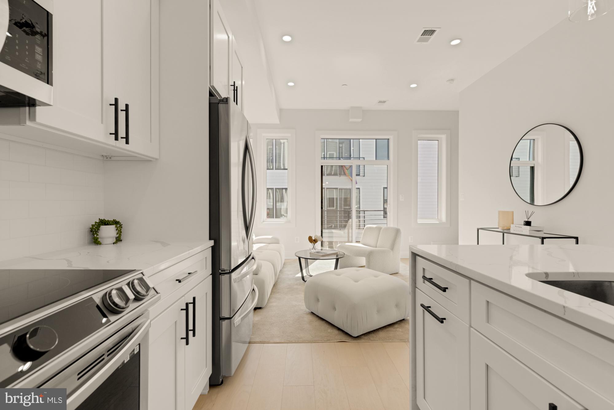 5505 7th Street Northwest, Unit 5 Washington, DC 20011 - Photo 9 of 27 a view of a kitchen with a sink and living room