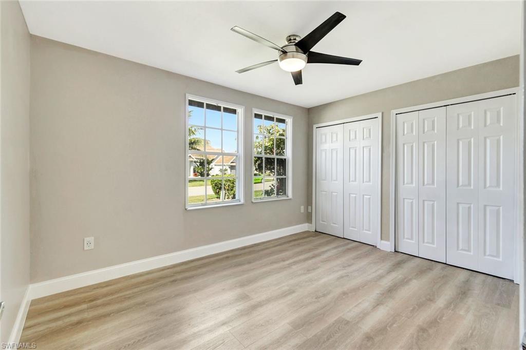 3650 Kent Drive Naples, FL 34112 - Photo 19 of 40 wooden floor in an empty room with a window