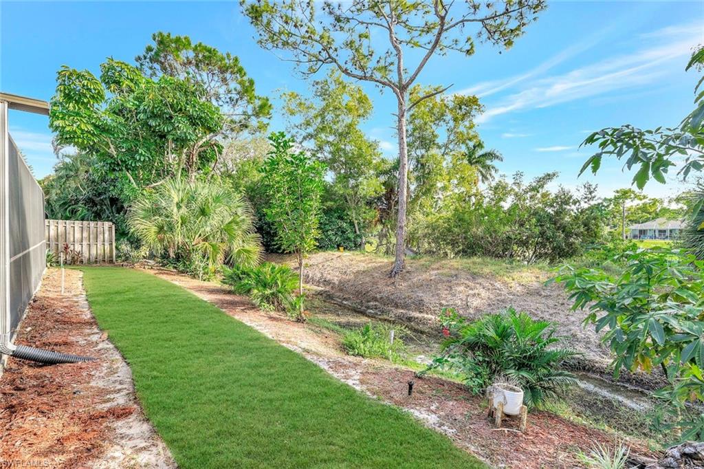 3650 Kent Drive Naples, FL 34112 - Photo 28 of 40 a view of a yard with plants and large trees