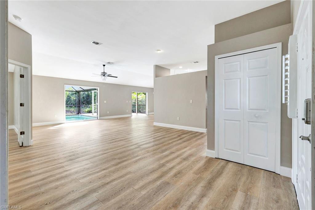 3650 Kent Drive Naples, FL 34112 - Photo 4 of 40 a view of an empty room with wooden floor and a window
