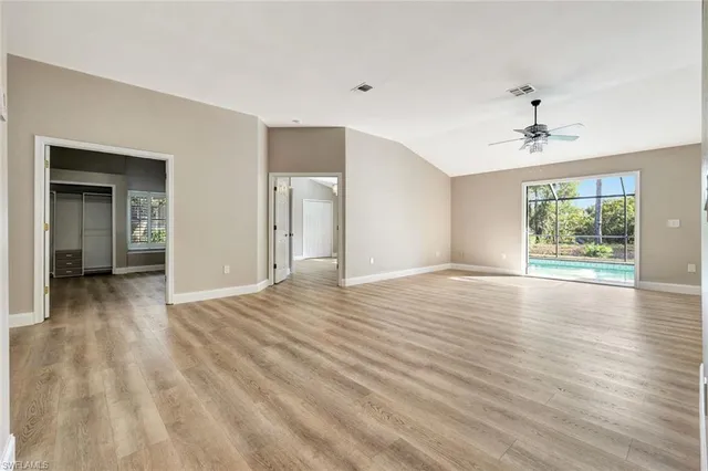 a view of a livingroom with wooden floor and a ceiling fan