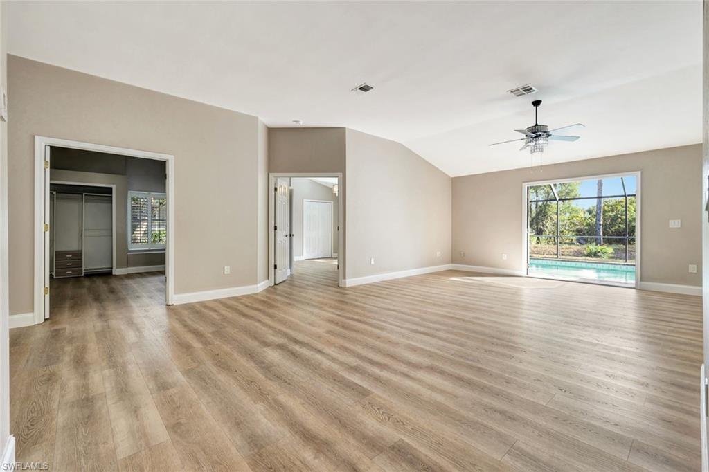 3650 Kent Drive Naples, FL 34112 - Photo 5 of 40 a view of a livingroom with wooden floor and a ceiling fan