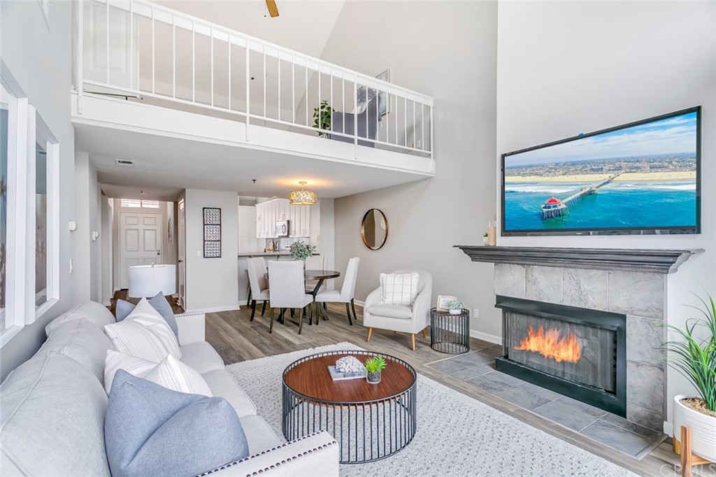 20331 Bluffside Circle, Unit A416 Huntington Beach, CA 92646 - Photo 13 of 42 a living room with furniture a rug and a fireplace