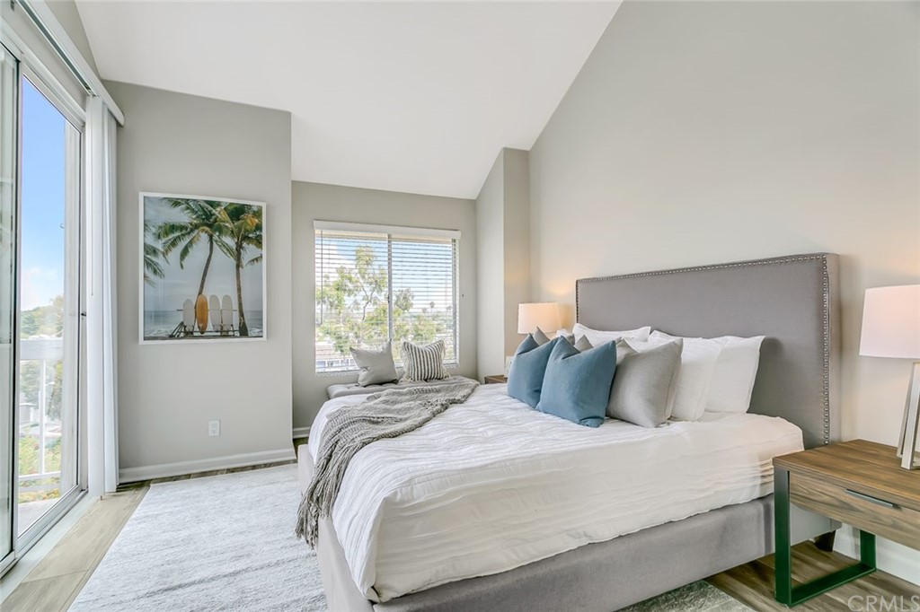 20331 Bluffside Circle, Unit A416 Huntington Beach, CA 92646 - Photo 16 of 42 a bedroom with a bed table and a window