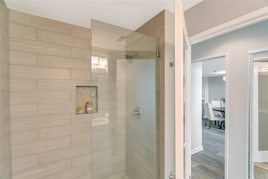 20331 Bluffside Circle, Unit A416 Huntington Beach, CA 92646 - Photo 20 of 42 a bathroom with a glass shower door