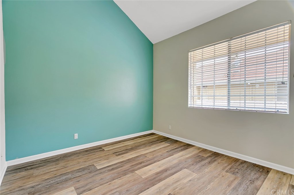 20331 Bluffside Circle, Unit A416 Huntington Beach, CA 92646 - Photo 21 of 42 an empty room with wooden floor and windows