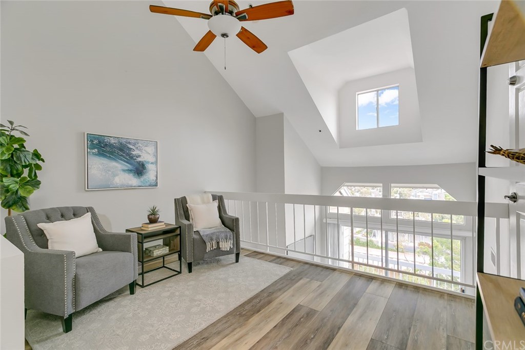 20331 Bluffside Circle, Unit A416 Huntington Beach, CA 92646 - Photo 27 of 42 a living room with furniture and a large window