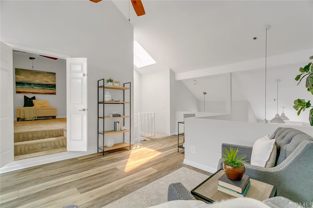 20331 Bluffside Circle, Unit A416 Huntington Beach, CA 92646 - Photo 28 of 42 a living room with furniture and a wooden floor