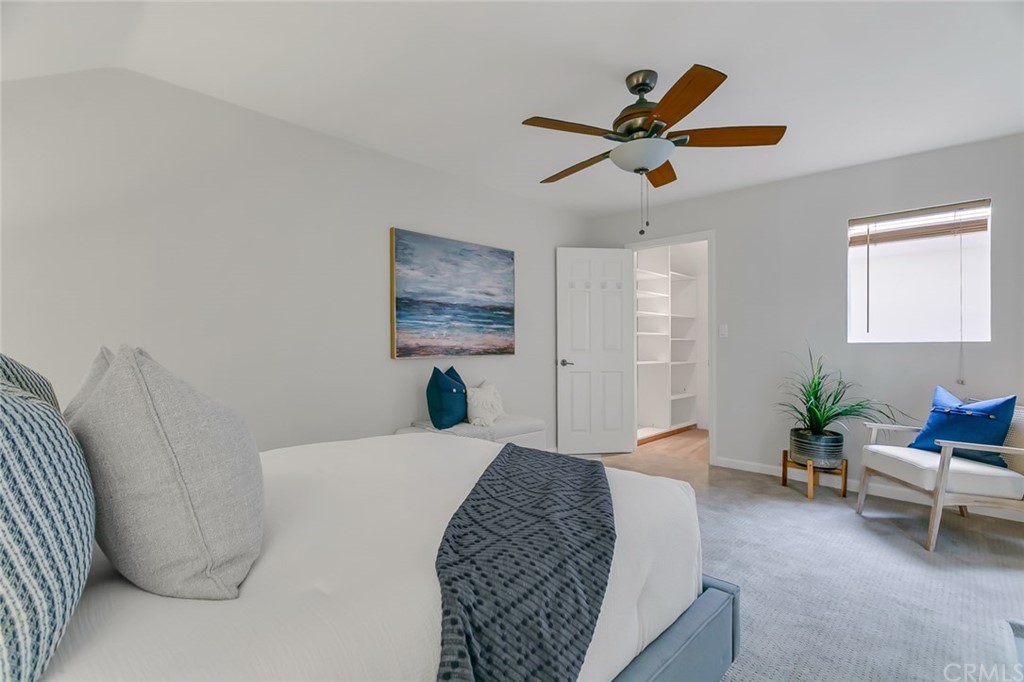 20331 Bluffside Circle, Unit A416 Huntington Beach, CA 92646 - Photo 30 of 42 a bed room with a bed and a chandelier