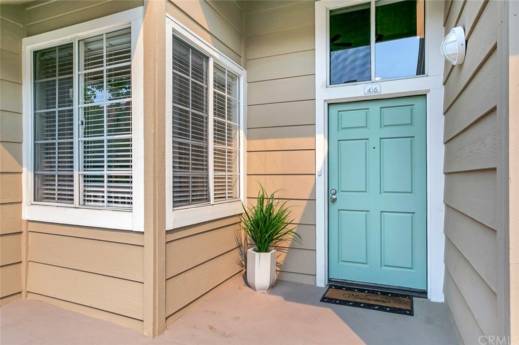 20331 Bluffside Circle, Unit A416 Huntington Beach, CA 92646 - Photo 3 of 42 a view of a house with a potted plant and a window