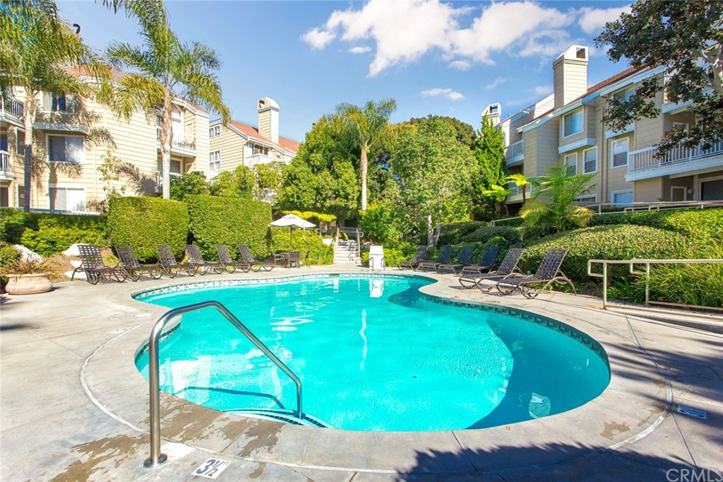 20331 Bluffside Circle, Unit A416 Huntington Beach, CA 92646 - Photo 33 of 42 a view of a swimming pool with a patio