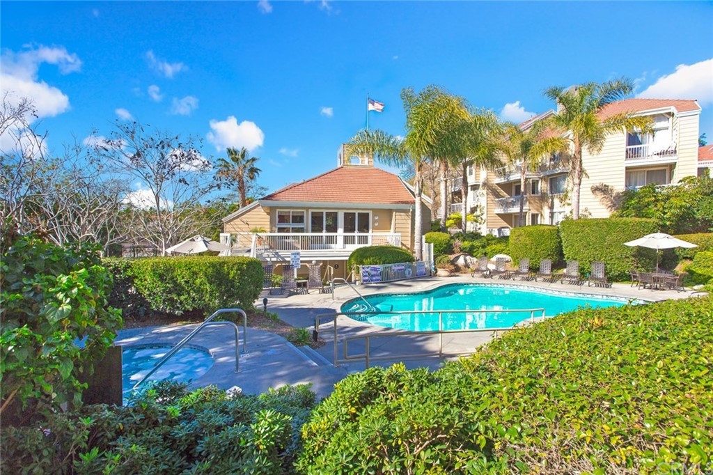 20331 Bluffside Circle, Unit A416 Huntington Beach, CA 92646 - Photo 36 of 42 a view of a swimming pool with a garden