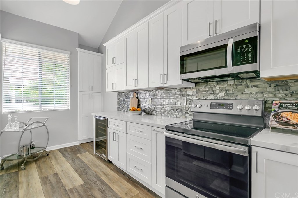 20331 Bluffside Circle, Unit A416 Huntington Beach, CA 92646 - Photo 6 of 42 a kitchen with appliances a sink and cabinets