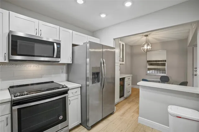 a kitchen with stainless steel appliances a stove microwave and a refrigerator