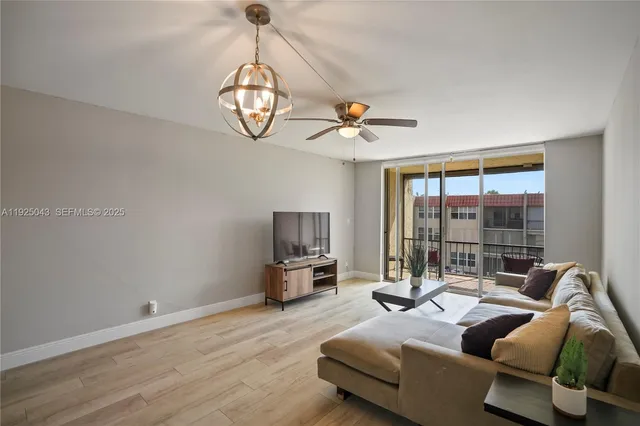 a living room with furniture ceiling fan and a window